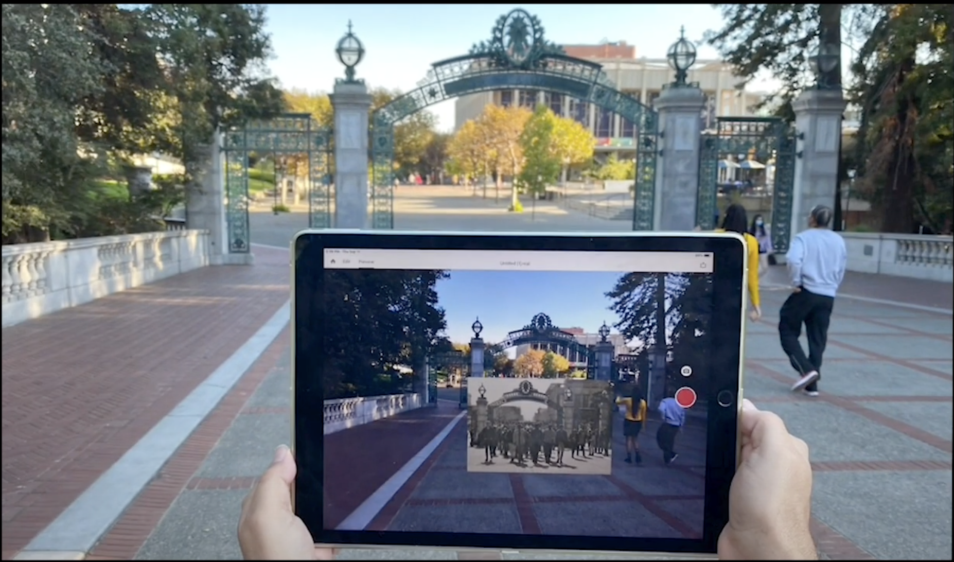 Student using augmented reality via a phone at Sather Gate